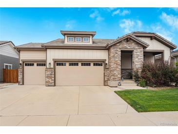 Beautiful two-story home with stone accents and a three-car garage at 15373 E 113Th Pl, Commerce City, CO 80022