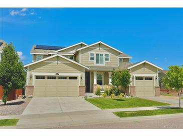 Two-story house with three car garage and landscaped yard at 14595 Vancouver Pl, Parker, CO 80134