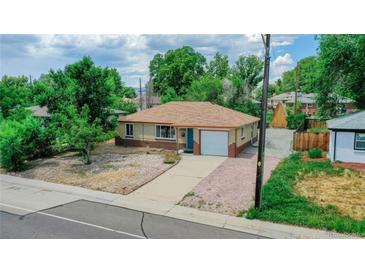 Ranch style home with a single car garage and well-maintained yard at 5395 Independence St, Arvada, CO 80002