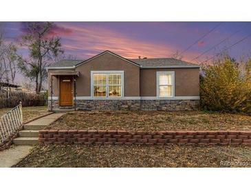 Charming ranch home with landscaped yard and brick accents at 4545 Raritan St, Denver, CO 80211