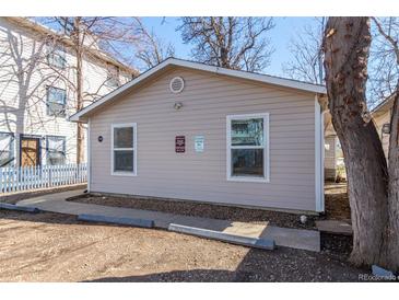 Tan colored house with a walkway and small yard at 1709 Arapahoe Ave, Boulder, CO 80302