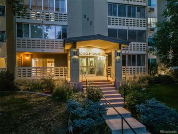 Night view of apartment building exterior with landscaping at 350 S Clinton St # 7A, Denver, CO 80247