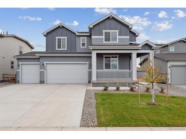 Two-story home with gray siding, three-car garage, and landscaped front yard at 5758 Ranch St, Mead, CO 80504