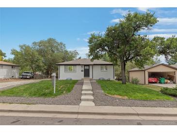 Charming ranch home with landscaped yard and detached garage at 7946 Joan Dr, Denver, CO 80221