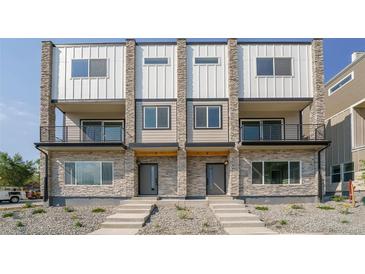 Modern two-unit building with stone accents and private entrances at 8500 W 62Nd Ave # H, Arvada, CO 80004