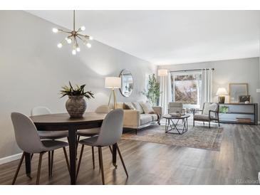 Open concept living and dining area with modern furniture at 4455 W Ponds Cir, Littleton, CO 80123