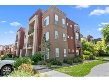 Modern condo building with attractive landscaping and ample parking at 14321 E Tennessee Ave # 1-105, Aurora, CO 80012