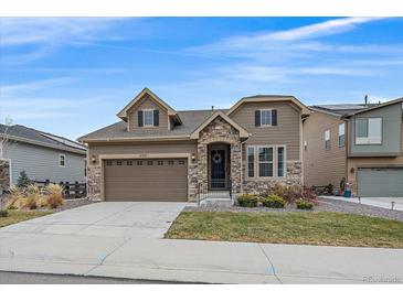 Two-story home with stone accents and a landscaped yard at 6335 E 143Rd Dr, Thornton, CO 80602