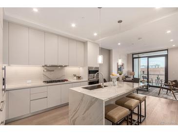 Modern kitchen with island, stainless steel appliances, and quartz countertops at 1901 Wazee St # 719, Denver, CO 80202