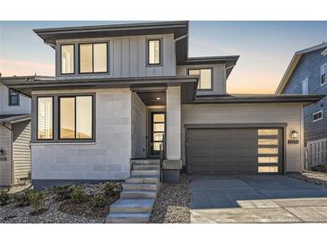 Two-story modern home with gray siding and a two-car garage at 11575 Toccata Trl, Parker, CO 80134