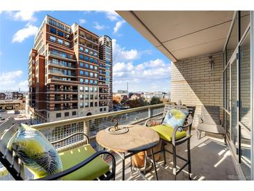 Urban balcony view with seating, showcasing city skyline at 1610 Little Raven St # 407, Denver, CO 80202