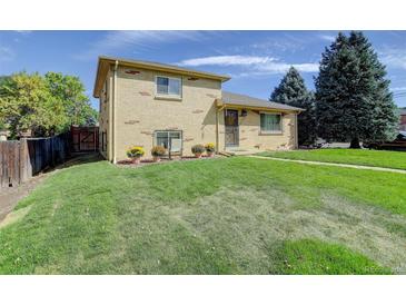 Brick ranch home with well-maintained lawn at 2488 S Zurich Ct, Denver, CO 80219