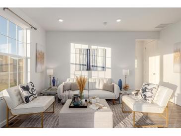 Bright living room with comfy seating and large windows at 15881 Willow Way, Thornton, CO 80602