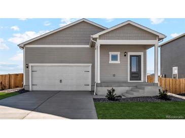 Craftsman style home with two-car garage and landscaped front yard at 7318 Arkansas St, Frederick, CO 80530