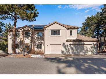 Two-story house with attached two-car garage and solar panels at 22141 Chippewa Ln, Golden, CO 80401