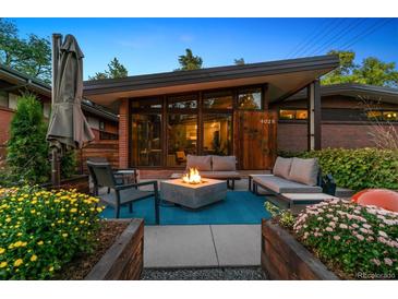 Mid-century modern home with a firepit and seating area in the backyard at 4025 Montview Blvd, Denver, CO 80207