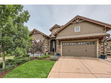 Two-story home with a large two-car garage and attractive landscaping at 711 Hiddenbrook Ct, Highlands Ranch, CO 80126