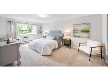 Bedroom with window, chair, and bedside tables at 660 S Alton Way # 7A, Denver, CO 80247