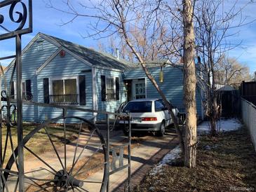 Blue house with a gated driveway and mature trees at 2648 S Pennsylvania St, Denver, CO 80210