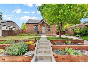 Brick home with landscaped yard and walkway at 1454 Rosemary St, Denver, CO 80220