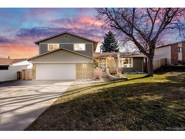 Two-story house with attached garage and landscaped yard at 3408 S Kittredge St, Aurora, CO 80013