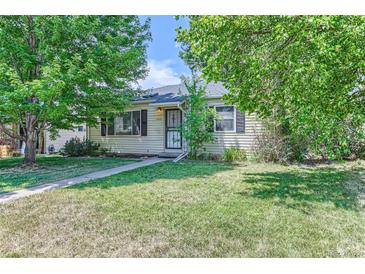 Ranch style home with a well-maintained lawn at 1525 S Bellaire St, Denver, CO 80222