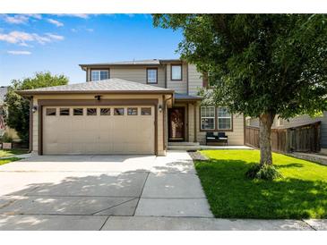 Two-story home with attached garage, well-maintained landscaping, and a welcoming facade at 1160 Cardinal Ave, Brighton, CO 80601