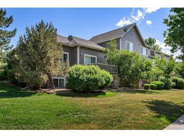 Attractive rear view of the home showcasing a deck and landscaping at 6061 W Utah Ln, Lakewood, CO 80232