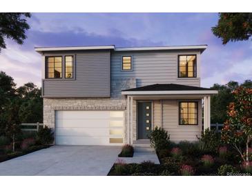 Two-story home with gray siding, stone accents, and a two-car garage at 8876 Whiteclover St, Littleton, CO 80125