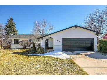 Updated ranch home with modern black accents and landscaped lawn at 10610 W Saratoga Pl, Littleton, CO 80127