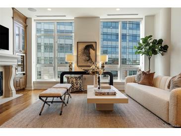 Bright living room with hardwood floors, large windows, and comfortable seating at 100 Detroit St # 406, Denver, CO 80206