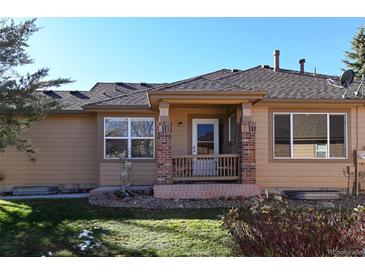 Back patio with brick columns and a small yard at 6475 Orion Way, Arvada, CO 80007