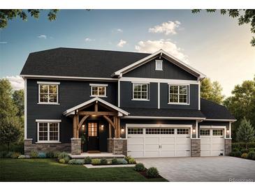 Two-story home with dark siding, stone accents, and three-car garage at 941 Saint Andrews Ln, Louisville, CO 80027
