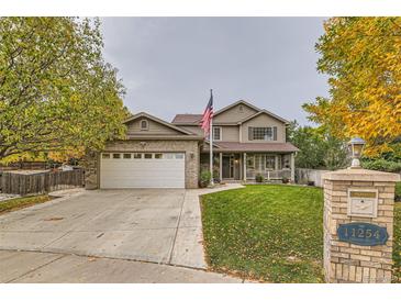 Two-story house with a large yard and attached garage at 11254 Oakland Dr, Commerce City, CO 80640