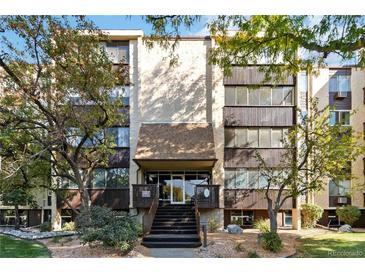 Condo building exterior with landscaping and steps leading to the entrance at 3460 S Poplar St # 307, Denver, CO 80224