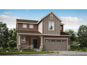 Two-story house with brown siding, beige accents, and a two-car garage at 185 Baler Ct, Brighton, CO 80601