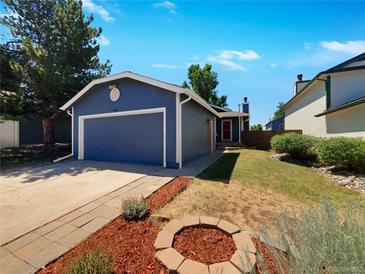 Charming single-story home with attached garage and landscaped yard at 544 James St, Highlands Ranch, CO 80126