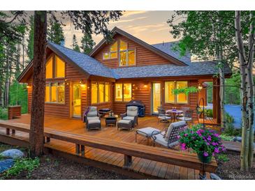 Lovely home exterior with deck and landscaping at dusk at 120 Windwood Cir, Breckenridge, CO 80424