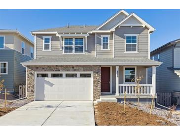 Two-story house with gray siding and a red door at 8389 Vona Ln, Littleton, CO 80125