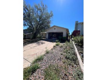Attached garage with driveway and landscaping at 18064 E Ford Pl, Aurora, CO 80017