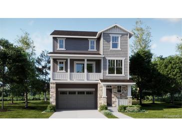 Two-story home with gray siding, stone accents, and a two-car garage at 6727 E 149Th Ave, Thornton, CO 80602