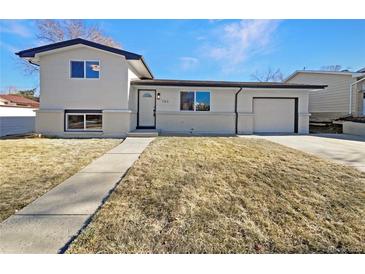 Updated Ranch home exterior boasts a fresh coat of paint and landscaping at 762 S Simms St, Lakewood, CO 80228