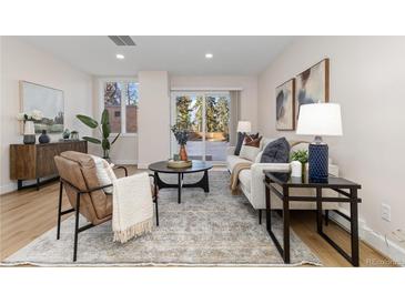 Spacious living room with sliding glass doors leading to a private outdoor patio at 1133 Race St # 1B, Denver, CO 80206