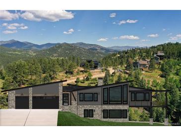 Modern house with mountain views and a three-car garage at 7142 Lynx Lair Rd, Evergreen, CO 80439