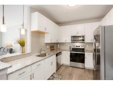 Modern kitchen with stainless steel appliances at 15700 E Jamison Dr # 8-103, Englewood, CO 80112