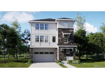Two-story home with stone accents and a two-car garage at 6736 E 149Th Dr, Thornton, CO 80602