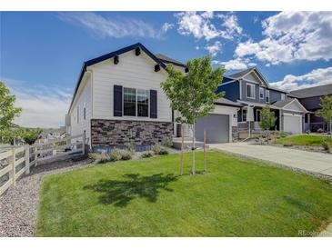 Two-story house with gray siding, white trim, and a green lawn at 5072 Ditmars Ln, Castle Rock, CO 80104