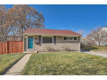 Cute ranch home with a red roof, teal door, and a well-maintained lawn at 1835 S Vallejo St, Denver, CO 80223