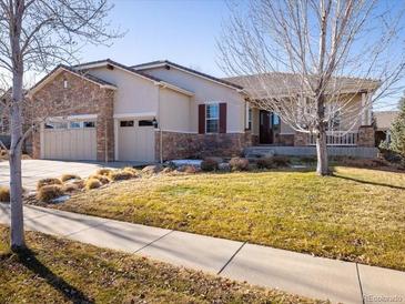 Beautiful two-story home with stone accents and a landscaped yard at 4651 Belford Cir, Broomfield, CO 80023