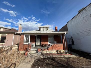 Brick home with a front porch and small yard at 2560 S Broadway, Denver, CO 80210
